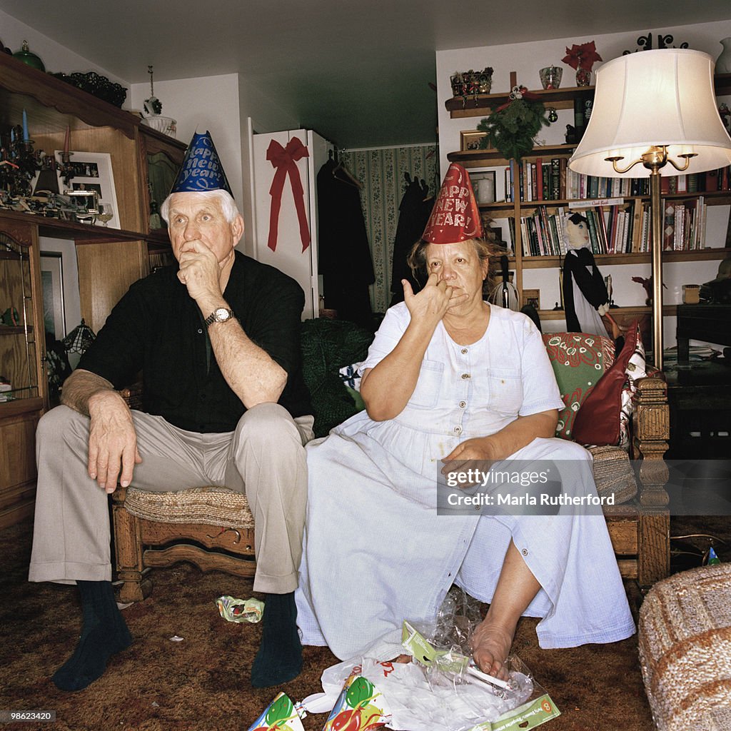 Lethargic couple in party hats