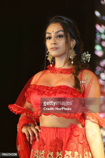 Indian model wearing an elegant and ornate outfit during a South Asian bridal fashion show held in Scarborough, Ontario, Canada.