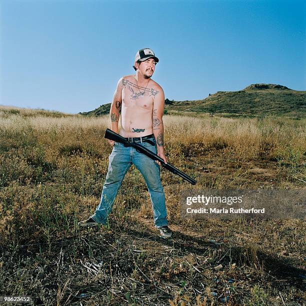 shirtless man holding shotgun - hillbilly bildbanksfoton och bilder