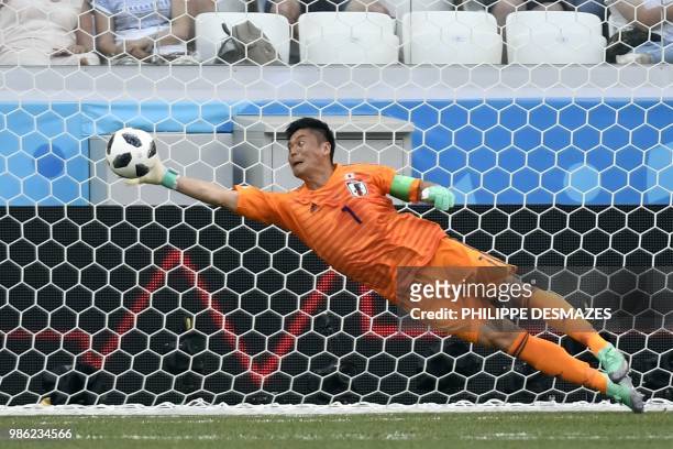 Japan's goalkeeper Eiji Kawashima jumps to make a save during the Russia 2018 World Cup Group H football match between Japan and Poland at the...