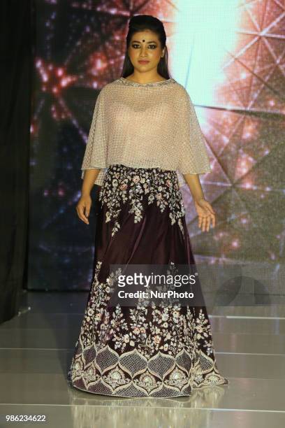 Indian model wearing an elegant and ornate outfit during a South Asian bridal fashion show held in Scarborough, Ontario, Canada.