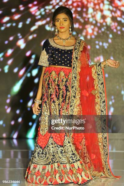 Indian model wearing an elegant and ornate outfit during a South Asian bridal fashion show held in Scarborough, Ontario, Canada.