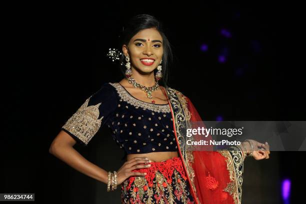 Indian model wearing an elegant and ornate outfit during a South Asian bridal fashion show held in Scarborough, Ontario, Canada.