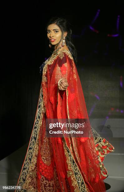 Indian model wearing an elegant and ornate outfit during a South Asian bridal fashion show held in Scarborough, Ontario, Canada.