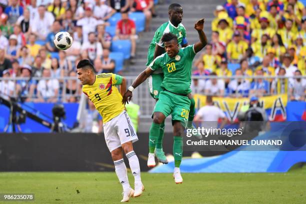 Senegal's forward Keita Balde and Senegal's midfielder Cheikhou Kouyate head the ball with Colombia's forward Falcao during the Russia 2018 World Cup...