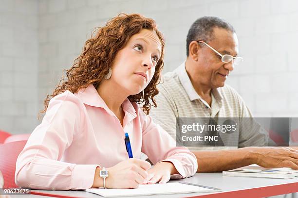 pensive student in college classroom - notation stock pictures, royalty-free photos & images