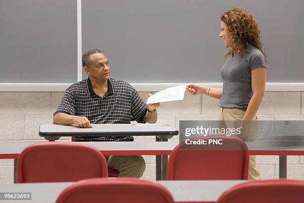 Handing In Homework Fotografías e imágenes de stock - Getty Images