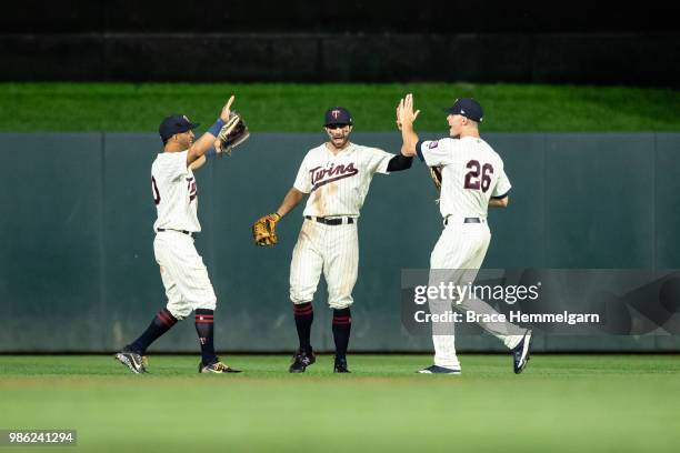 Eddie Rosario, Ryan LaMarre and Max Kepler of the Minnesota Twins celebrate against the Boston Red Sox on June 20, 2018 at Target Field in...