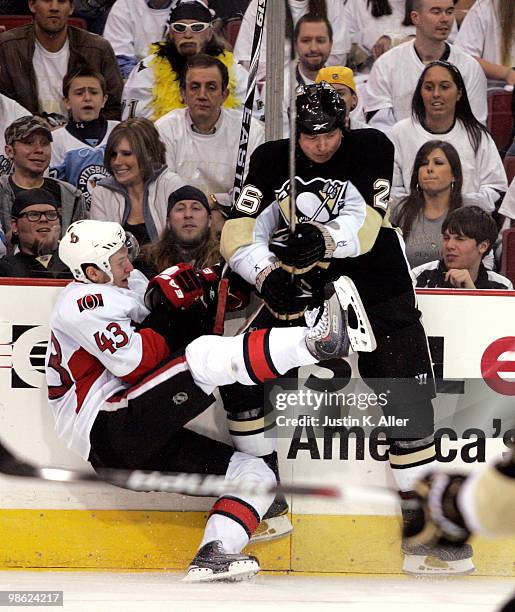 Ruslan Fedotenko of the Pittsburgh Penguins hits Peter Regin of the Ottawa Senators in Game Five of the Eastern Conference Quarterfinals during the...