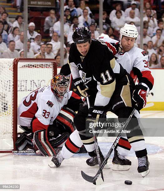 Jordan Staal of the Pittsburgh Penguins handles the puck in front of Matt Carkner of the Ottawa Senators in Game Five of the Eastern Conference...