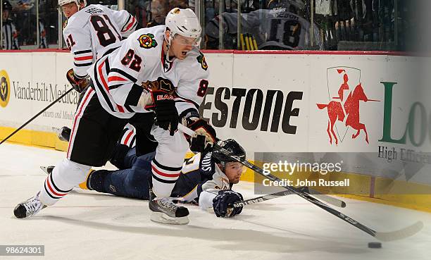 Dan Hamhuis of the Nashville Predators reaches out from the ice to poke the puck away from Tomas Kopecky of the Chicago Blackhawks in Game Four of...