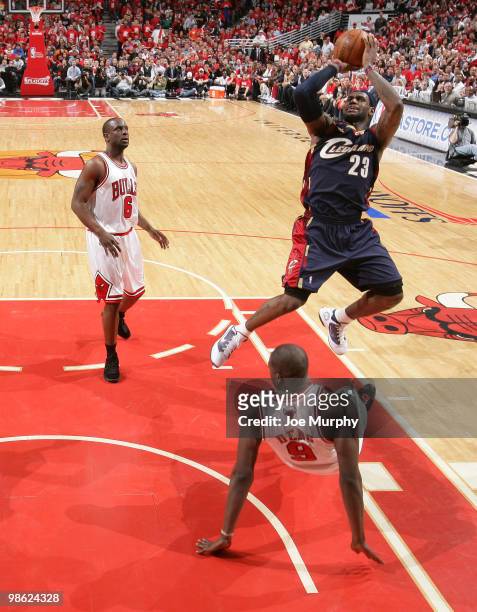 LeBron James of the Cleveland Cavaliers shoots over Luol Deng and Ronald Murray of the Chicago Bulls in Game Three of the Eastern Conference...