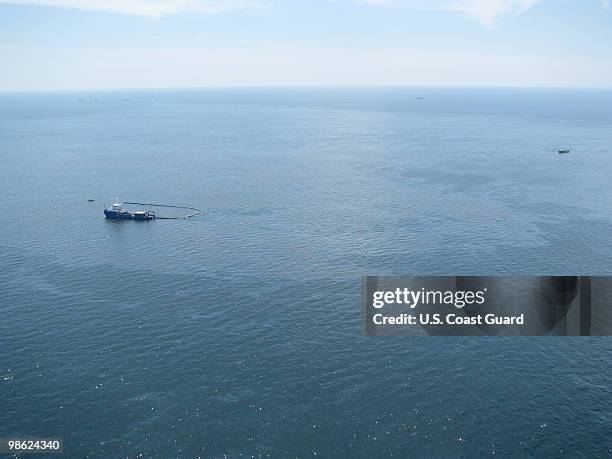 Response boats work to clean up oil where the Deepwater Horizon oilrig sank April 22, 2010 in the Gulf of Mexico off the coast of Louisiana.. The...