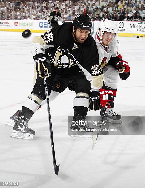 Maxime Talbot of the Pittsburgh Penguins battles for the puck against Erik Karlsson of the Ottawa Senators in Game Five of the Eastern Conference...