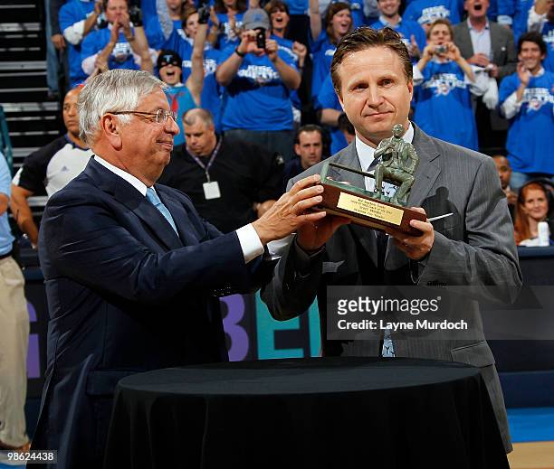 Commissioner, David Stern, hands the Red Auerbach Trophy to Scott Brooks, Head Coach of the Oklahoma City Thunder for the 2009-10 NBA Coach of the...