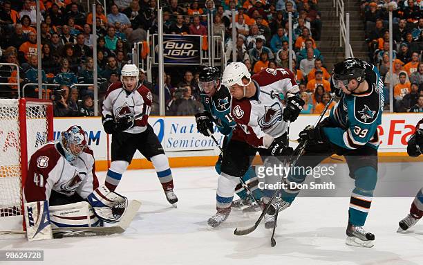 Craig Anderson, Kyle Cumiskey and Adam Foote of the Colorado Avalanche defend the net against Logan Couture and Dany Heatley of the San Jose Sharks...