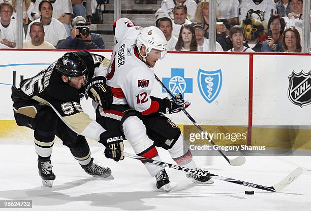 Sergei Gonchar of the Pittsburgh Penguins battles for the puck against Mike Fisher of the Ottawa Senators in Game Five of the Eastern Conference...