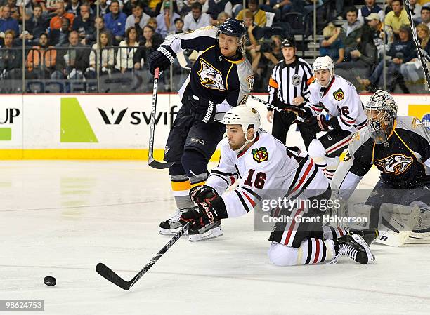 Andrew Ladd of the Chicago Blackhawks dives to stop a puck blocked by goalkeeper Pekka Rinne of the Nashville Predators in Game Four of the Eastern...