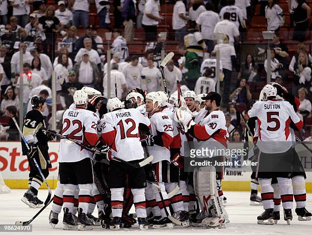 Matt Carkner of the Ottawa Senators is mobbed by teammates after scoring the game winning goal against the Pittsburgh Penguins in the third overtime...