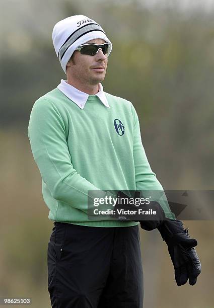 Brett Rumford of Australia putts his gloves on the 14th tee during the fog-delayed Round One of the Ballantine's Championship at Pinx Golf Club on...