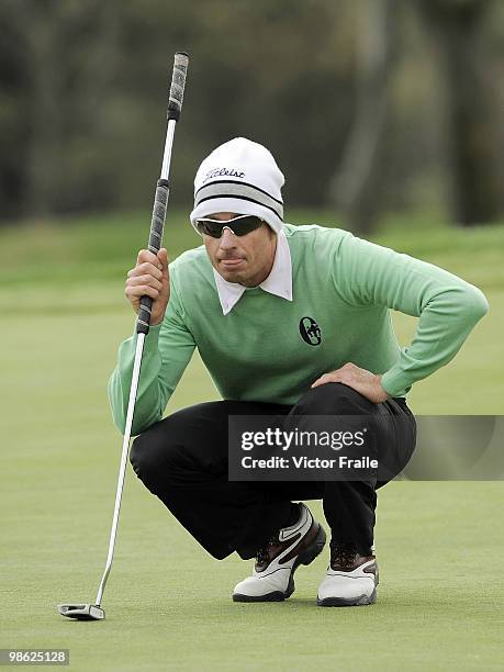 Brett Rumford of Australia lines up a putt on the 14th gree during the fog-delayed Round One of the Ballantine's Championship at Pinx Golf Club on...