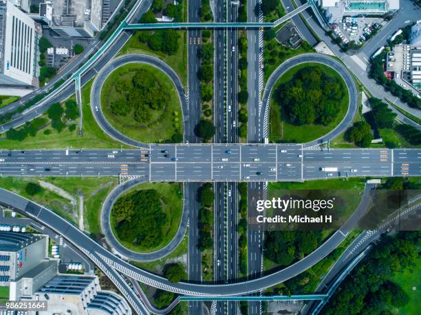 a crossing highway. scenery of the town with trees. - バイパス ストックフォトと画像