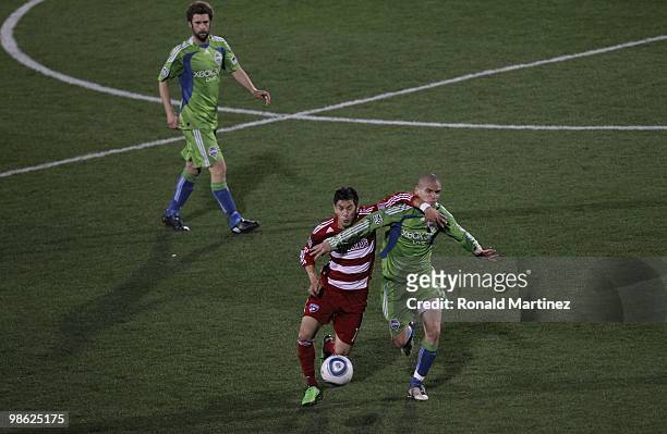 Midfielder Osvaldo Alonso of the Seattle Sounders dribbles the ball against Eric Avila of FC Dallas at Pizza Hut Park on April 22, 2010 in Frisco,...