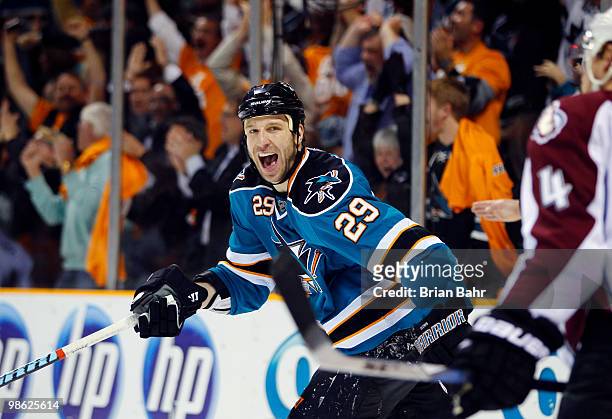 Ryane Clowe of the San Jose Sharks celebrates his assist around John-Michael Liles of the Colorado Avalanche during the third period of Game Five of...