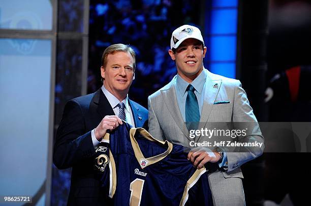 Quarterback Sam Bradford from the Oklahoma Sooners poses with NFL Commissioner Roger Goodell as they hold up a St. Louis Rams jersey after the Rams...