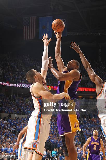 Andrew Bynum of the Los Angeles Lakers shoots against Nick Collison of the Oklahoma City Thunder in Game Three of the Western Conference...