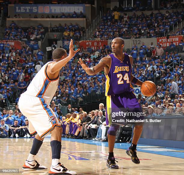 Kobe Bryant of the Los Angeles Lakers dribbles against Thabo Sefolosha of the Oklahoma City Thunder in Game Three of the Western Conference...
