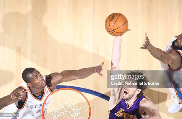 Pau Gasol of the Los Angeles Lakers shoots against Serge Ibaka and James Harden of the Oklahoma City Thunder in Game Three of the Western Conference...