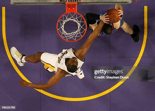 Andrew Bynum of the Los Angeles Lakers reaches for a rebound against Nick Collison of the Oklahoma City Thunder during Game One of the Western...