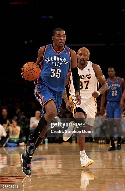 Kevin Durant of the Oklahoma City Thunder drives with the ball ahead of Ron Artest of the Los Angeles Lakers during Game One of the Western...