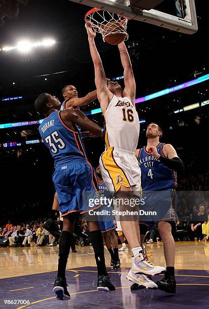 Pau Gasol of the Los Angeles Lakers dunks over Kevin Durant and Nick Collison of the Oklahoma City Thunder during Game One of the Western Conference...