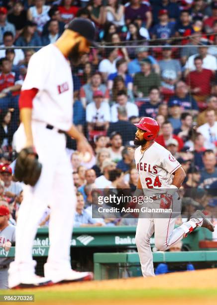 David Price of the Boston Red Sox looks on as Chris Young of the Los Angeles Angels rounds the bases after hitting a solo home run in the third...