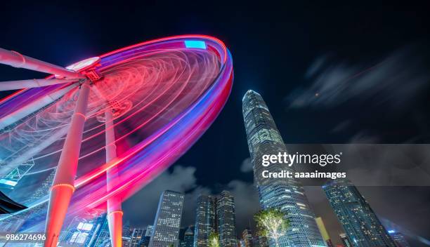 illuminated big wheel with two international finance center against sky - two international finance center stock-fotos und bilder