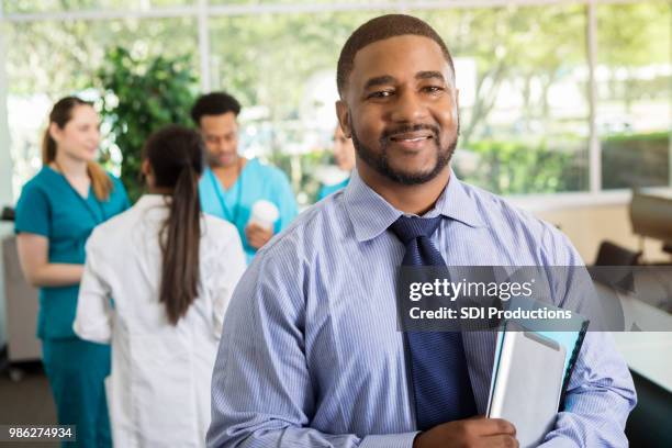 confident mid adult doctor at medical conference - study participant stock pictures, royalty-free photos & images