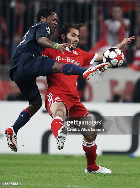 Hamit Altintop of Muenchen is challenged by Michel Bastos of Lyon during the UEFA Champions League semi final first leg match between FC Bayern...