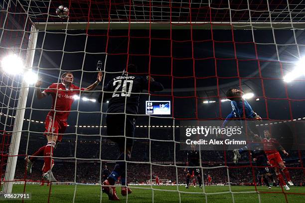 Bastian Schweinsteiger of Muenchen fails to score with a header against Aly Cissokho and goalkeeper Hugo Lloris of Lyon during the UEFA Champions...