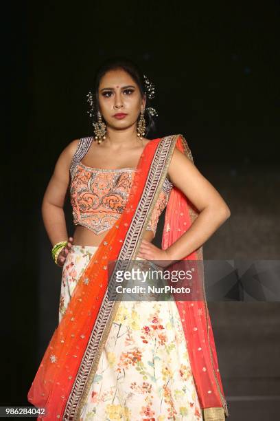 Indian model wearing an elegant and ornate half-saree during a South Asian bridal fashion show held in Scarborough, Ontario, Canada.