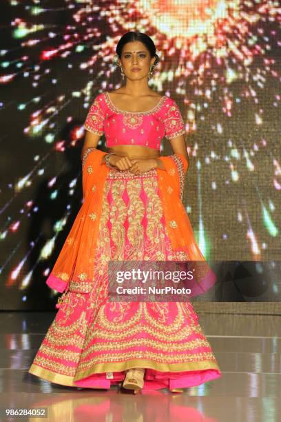 Indian model wearing an elegant and ornate outfit during a South Asian bridal fashion show held in Scarborough, Ontario, Canada.