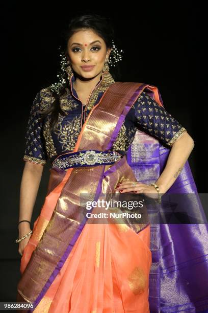 Indian model wearing an elegant and ornate half-saree during a South Asian bridal fashion show held in Scarborough, Ontario, Canada.