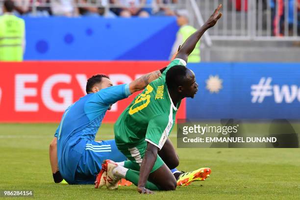 Senegal's forward Sadio Mane reacts next to Colombia's goalkeeper David Ospina during the Russia 2018 World Cup Group H football match between...