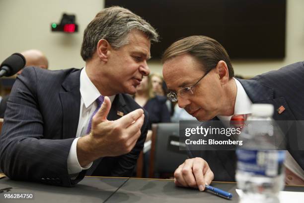 Christopher Wray, director of the Federal Bureau of Investigation , speaks to Rod Rosenstein, deputy attorney general, right, before the start of a...