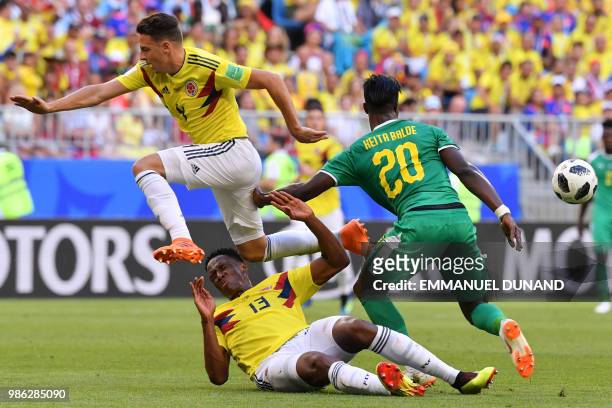 Senegal's forward Keita Balde challenges Colombia's defender Yerry Mina and Colombia's defender Santiago Arias during the Russia 2018 World Cup Group...