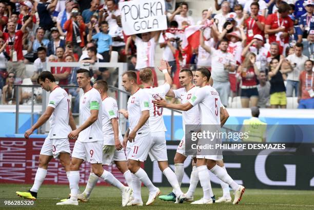 Poland's defender Jan Bednarek celebrates with teammates after scoring the opener during the Russia 2018 World Cup Group H football match between...