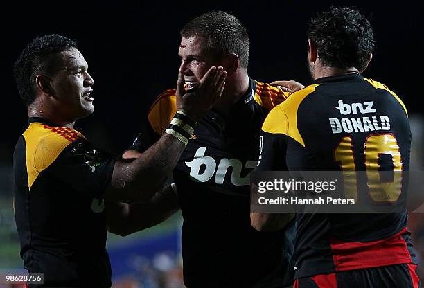 Toby Smith of the Chiefs celebrates with Hika Elliot and Stephen Donald after scoring during the round 11 Super 14 match between the Chiefs and the...