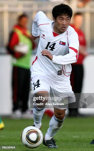 Ri Chol Myong of North Korea runs with the ball during the... News