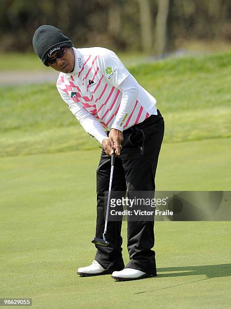 Thongchai Jaidee of Thailand putts on the 13th green during the fog-delayed Round One of the Ballantine's Championship at Pinx Golf Club on April 23,...